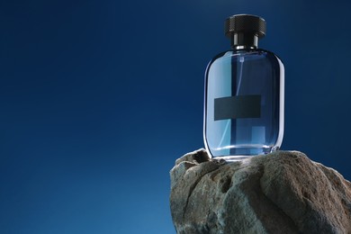 Stylish presentation of luxury men`s perfume on stone against light blue background. Space for text