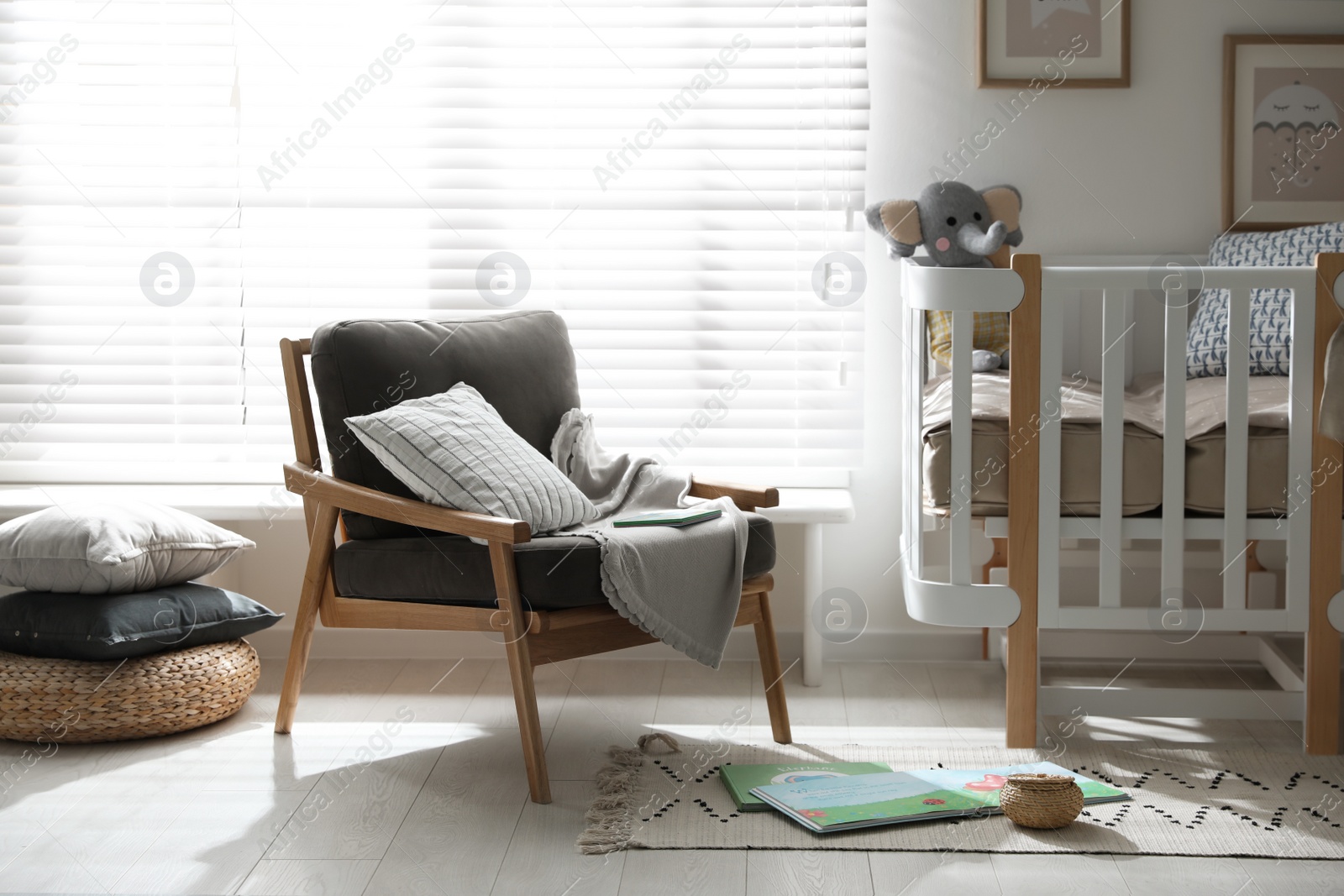 Photo of Baby room interior with crib and armchair. Idea for design