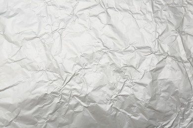 Photo of Crumpled silver foil as background, top view