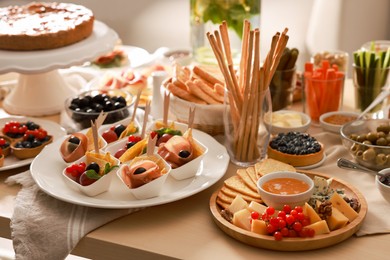 Photo of Dishes with different food on table in room. Luxury brunch