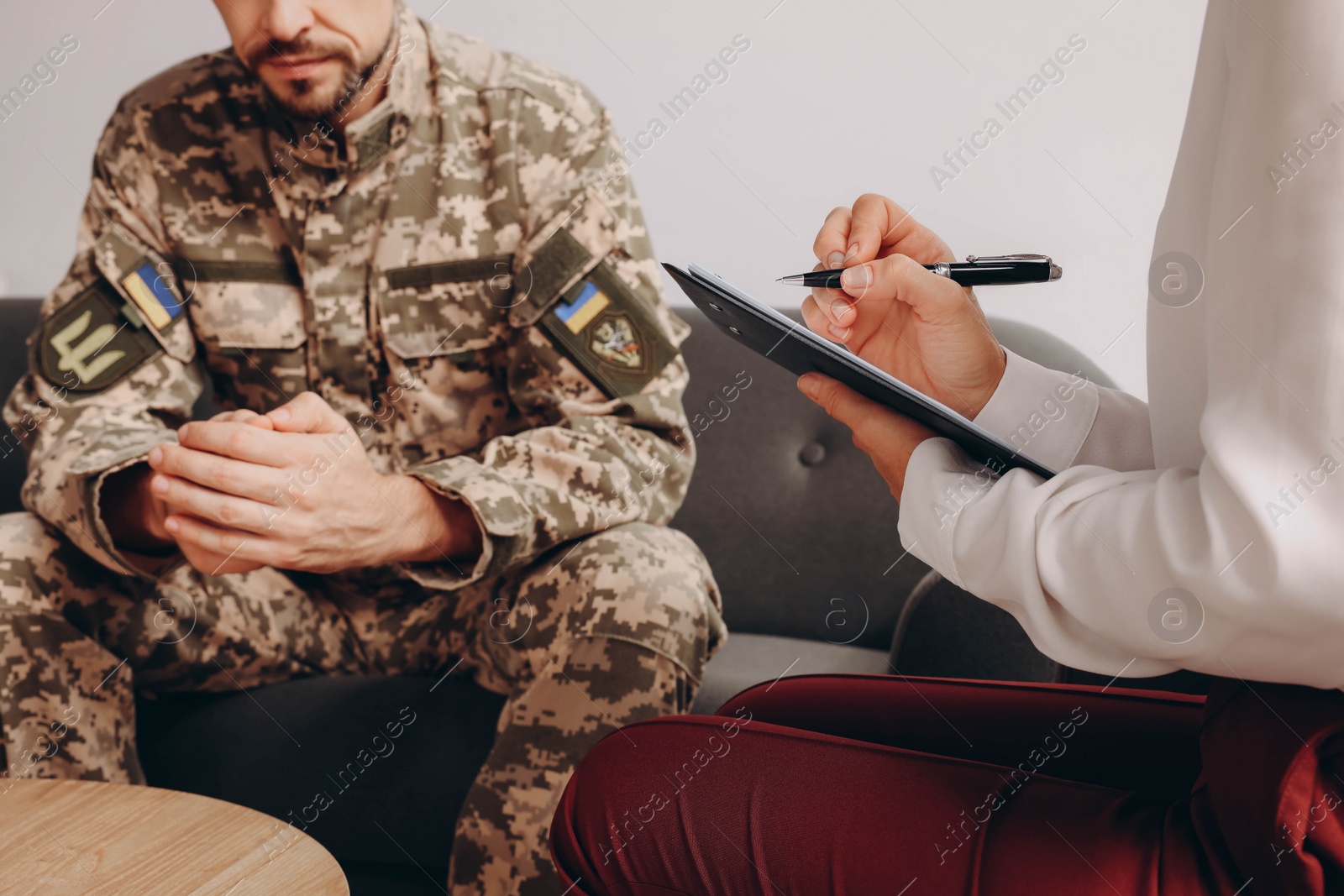 Photo of Psychologist working with military officer indoors, closeup