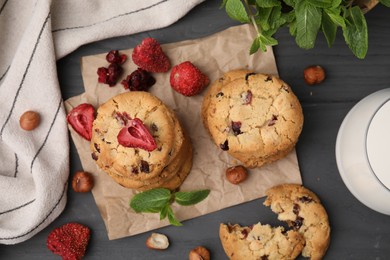 Photo of Cookies with freeze dried fruits, mint and nuts on grey table, flat lay