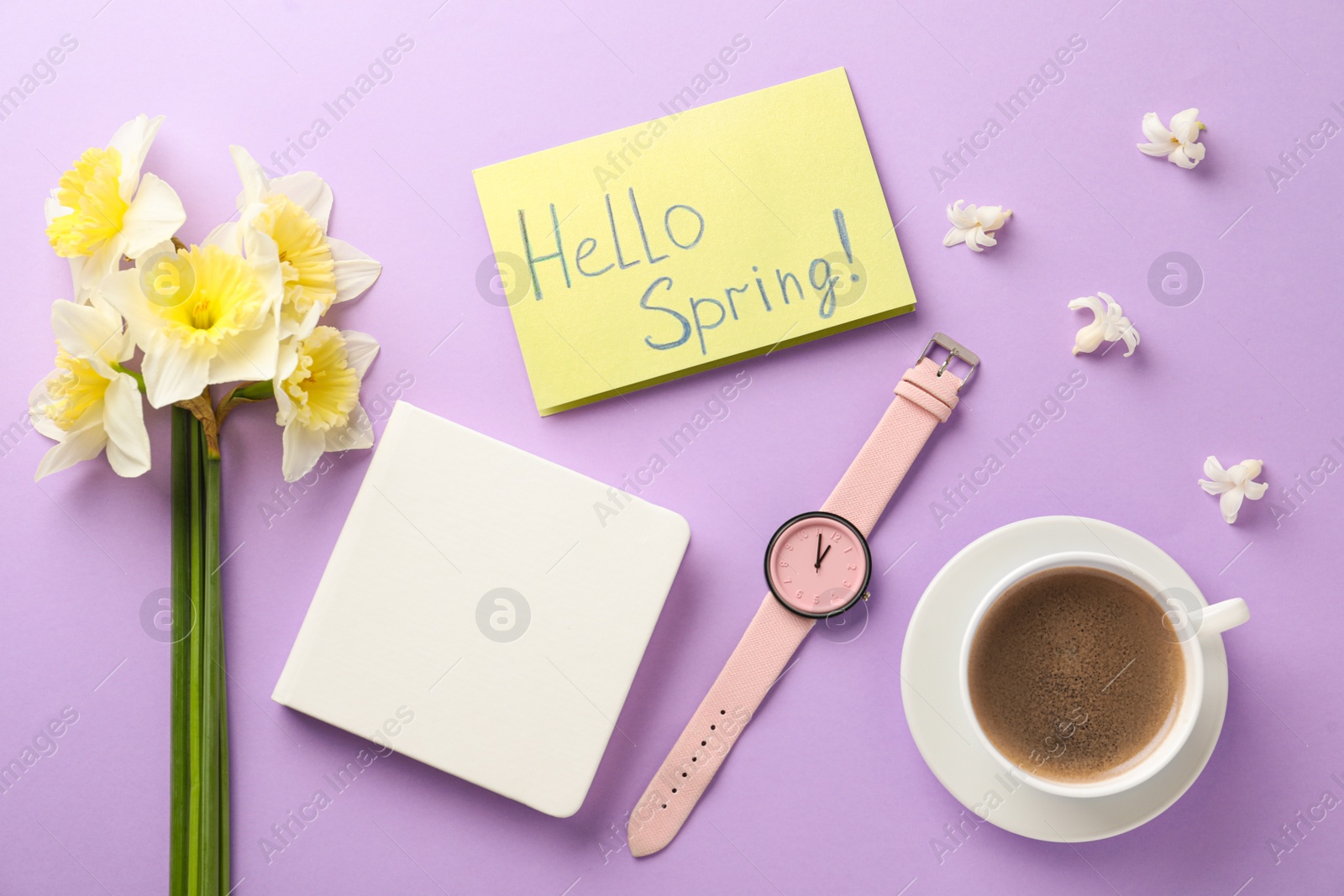 Photo of Flat lay composition with words HELLO SPRING, coffee, wristwatch and fresh flowers on violet background