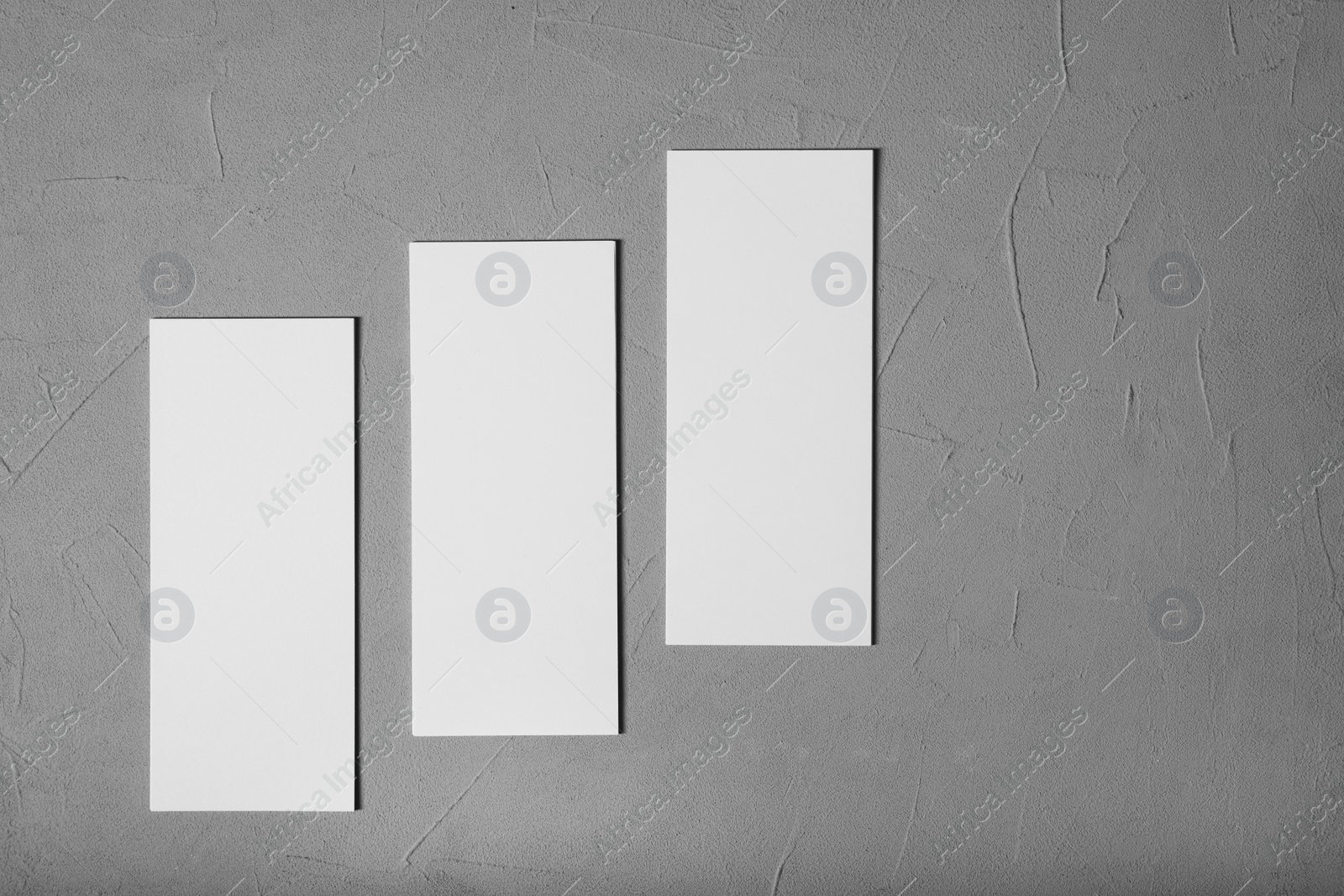Photo of Blank business cards on grey textured background, top view. Mockup for design
