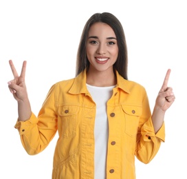 Woman in yellow jacket showing number three with her hands on white background