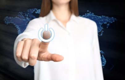 Woman pressing power button on virtual screen, closeup 