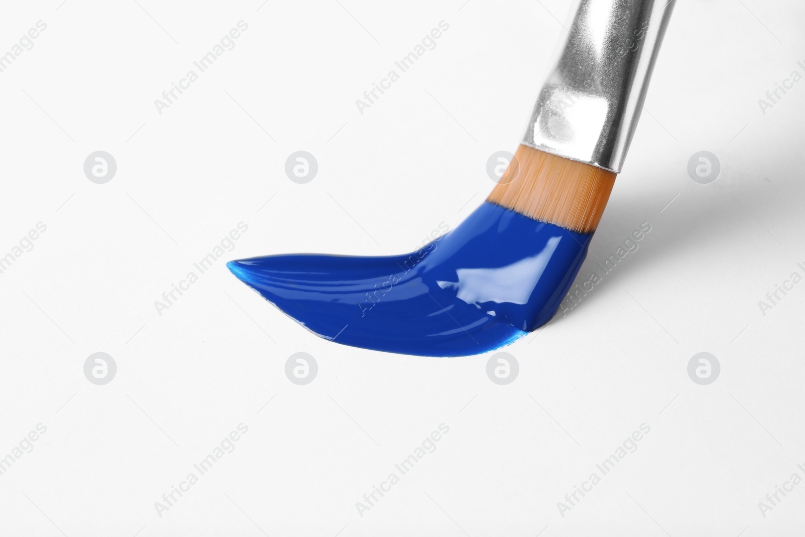 Photo of Brush with color paint and stroke on white background