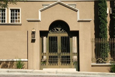 Photo of Entrance of house with beautiful door and metal gate
