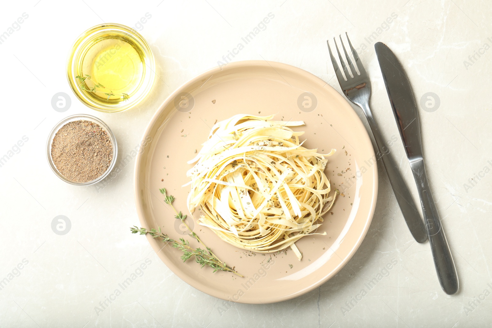 Photo of Fresh white carrot salad served with oil and spices on light table, flat lay