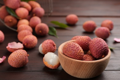 Photo of Fresh ripe lychee fruits on wooden table
