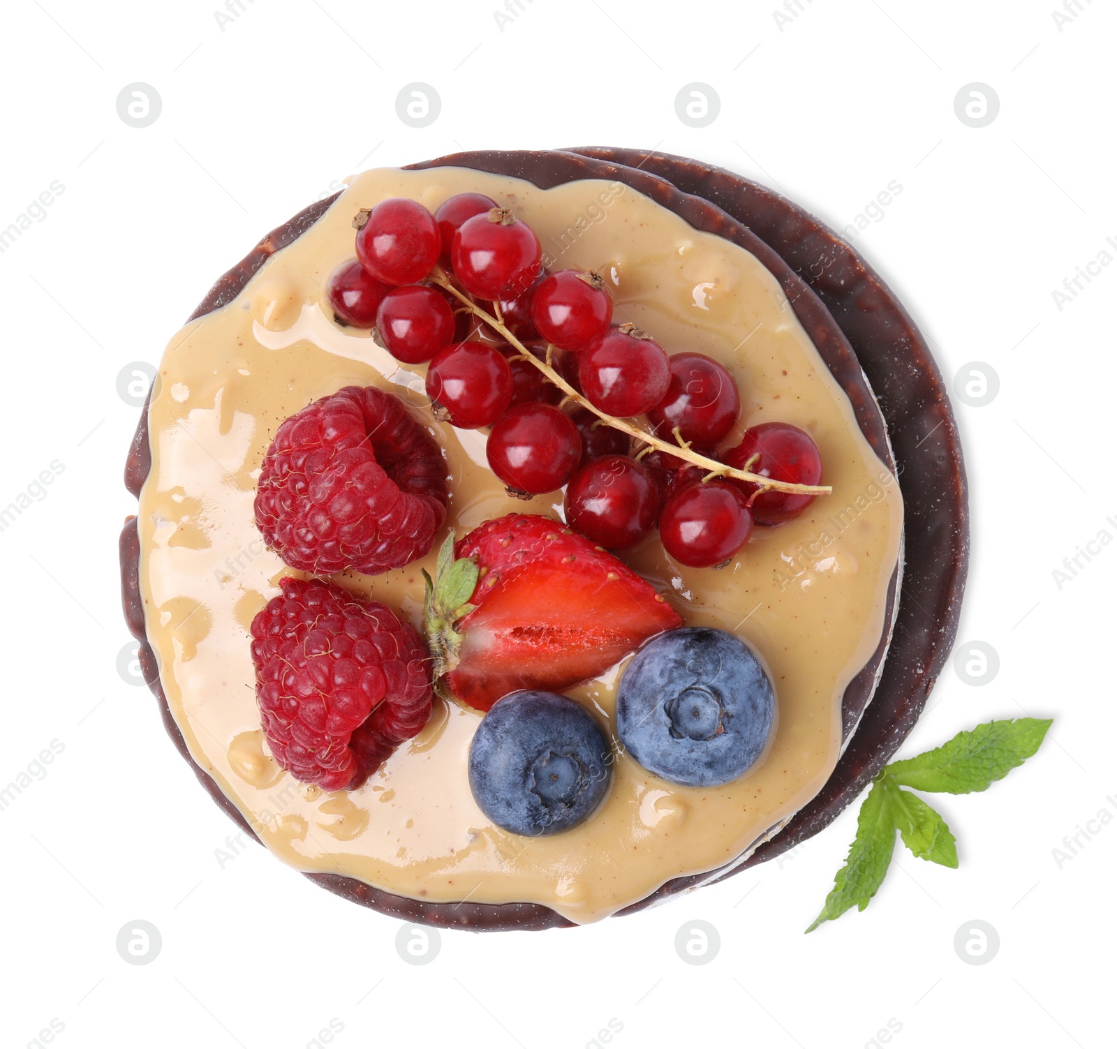 Photo of Crunchy rice cakes with peanut butter and sweet berries isolated on white, top view