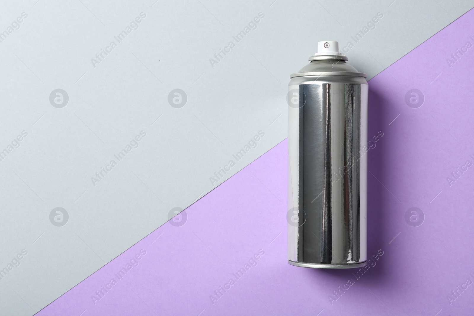 Photo of Can of spray paint on color background, top view. Space for text