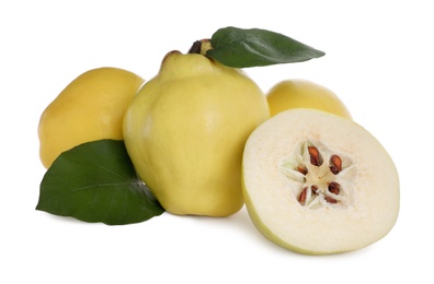 Photo of Whole and cut delicious quinces on white background