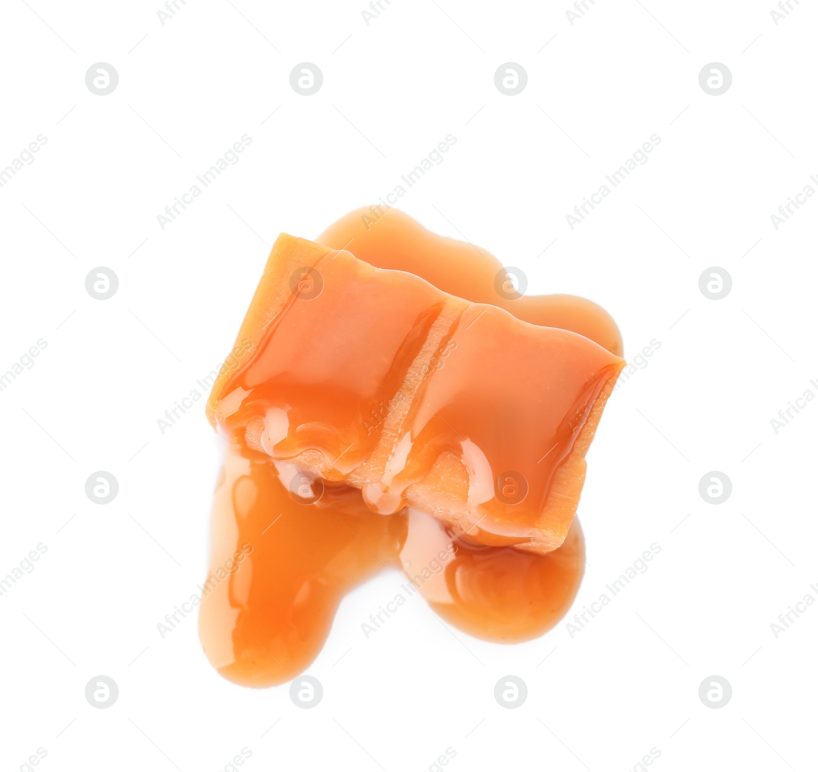 Photo of Delicious candy with caramel sauce on white background