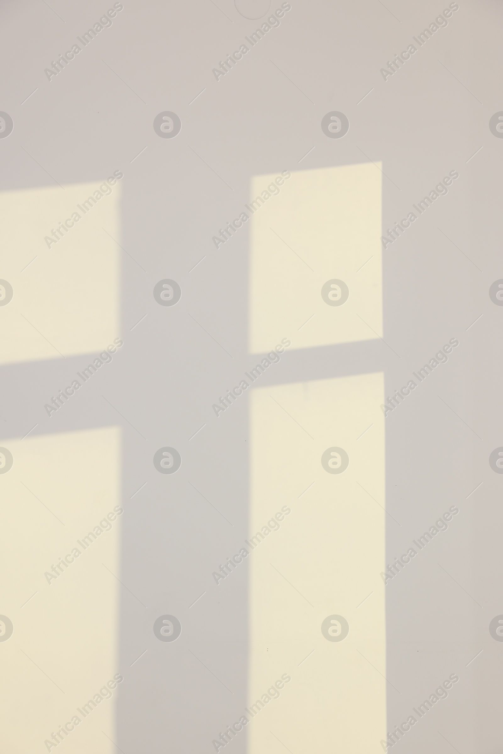 Photo of Light and shadows from window on wall indoors