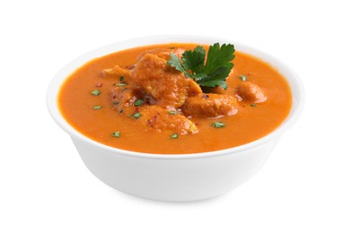 Bowl of delicious chicken curry on white background