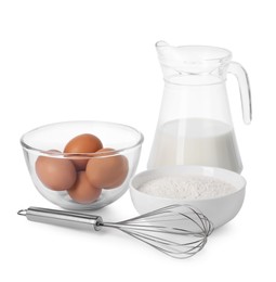 Photo of Metal whisk, raw eggs, flour and jug of milk isolated on white