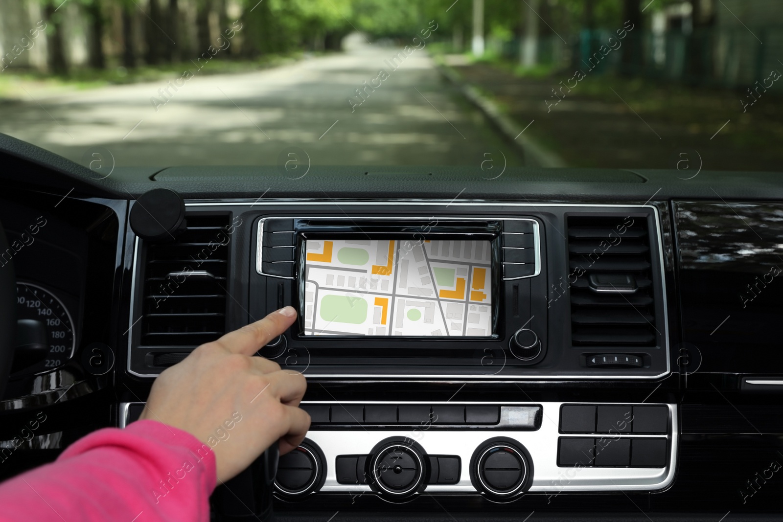 Image of Woman using navigation system while driving car, closeup