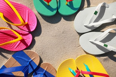 Stylish flip flops on beach, flat lay. Space for text