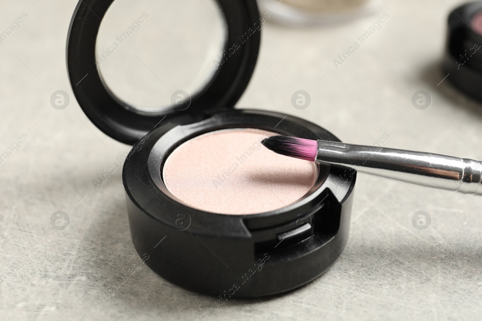 Photo of Eye shadow with makeup brush on table, closeup