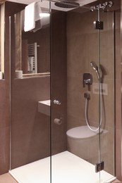 Photo of Stylish bathroom with shower stall in luxury hotel. Interior design