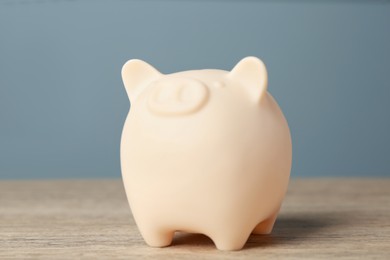 Photo of Ceramic piggy bank on wooden table. Financial savings