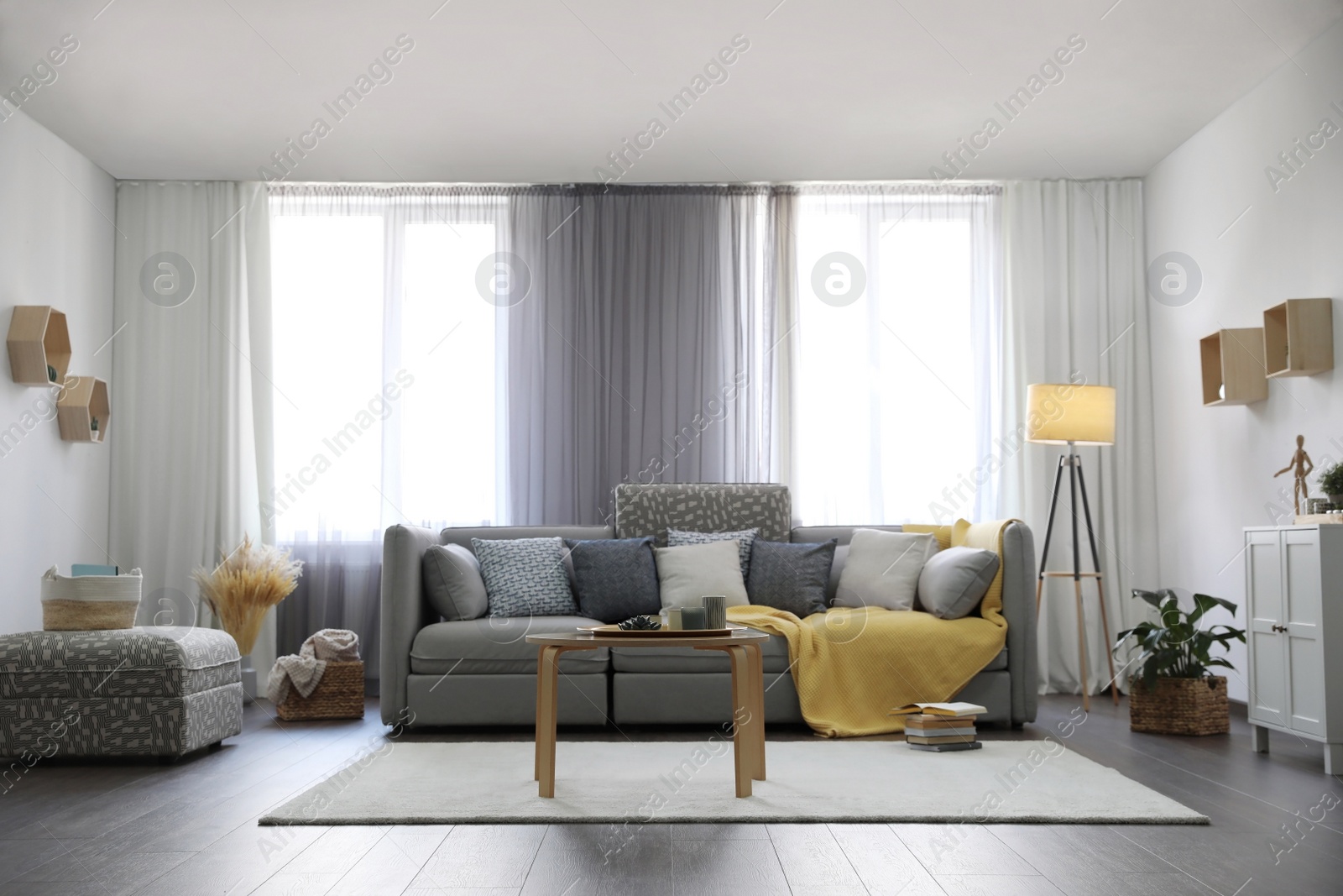 Photo of Elegant living room with comfortable sofa near windows. Interior design