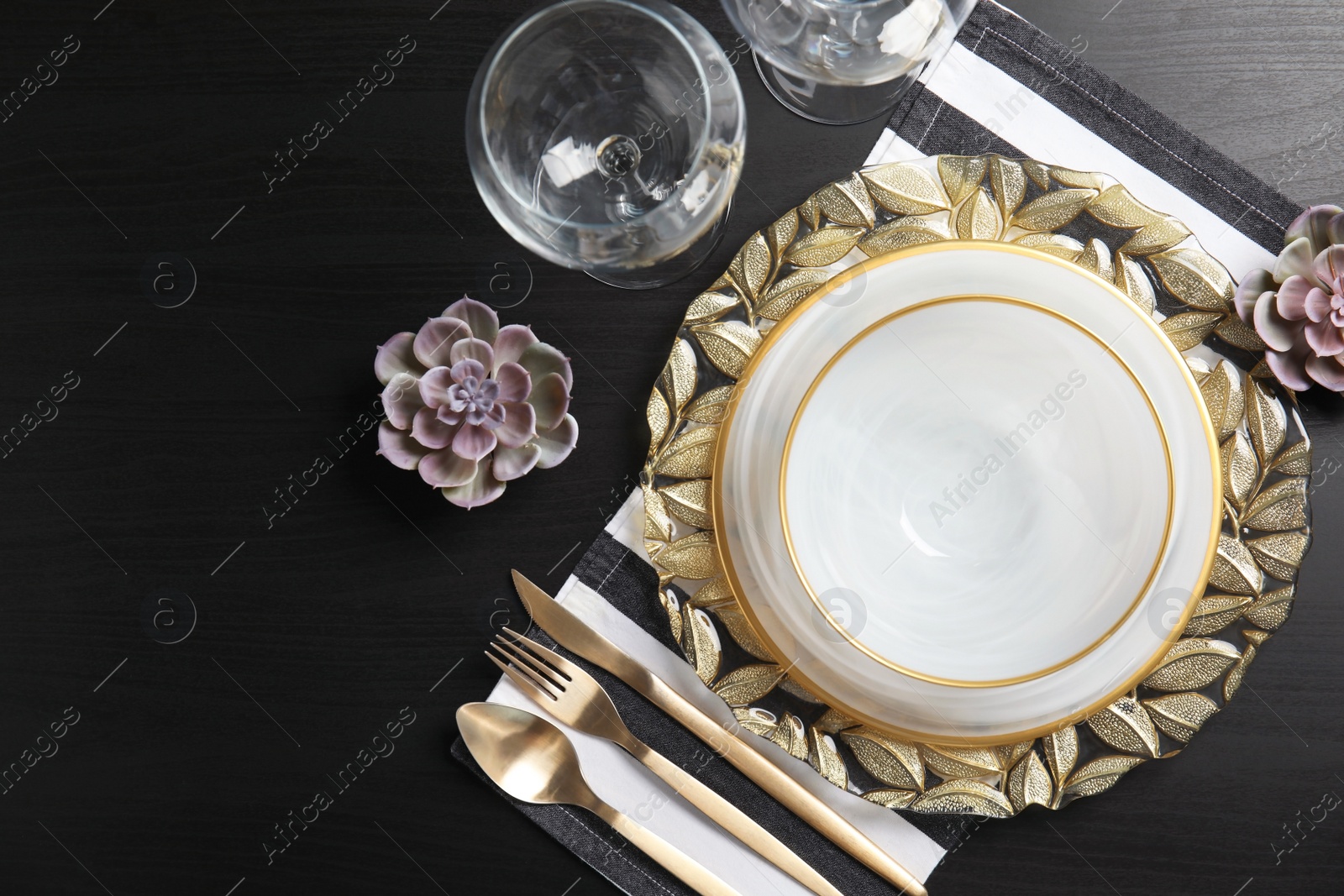 Photo of Elegant table setting on dark background, top view