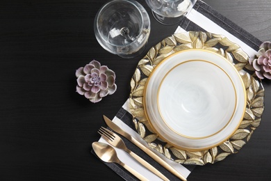 Elegant table setting on dark background, top view