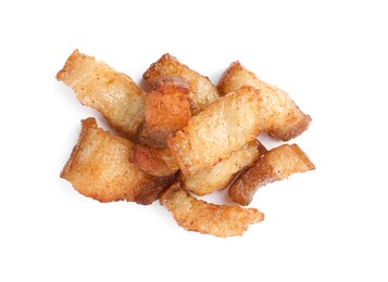 Photo of Tasty fried cracklings on white background, top view. Cooked pork lard