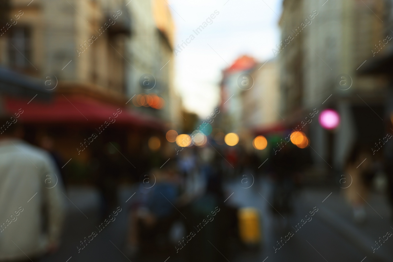 Photo of Blurred view of people walking on city street