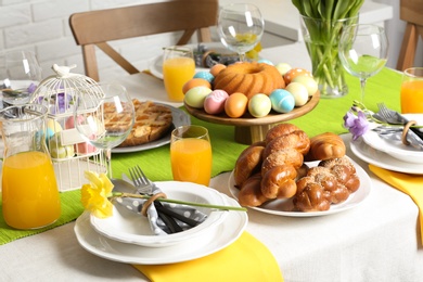 Photo of Festive Easter table setting with traditional meal at home