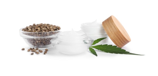 Photo of Jars with hemp cream, seeds and green leaf on white background. Natural cosmetics