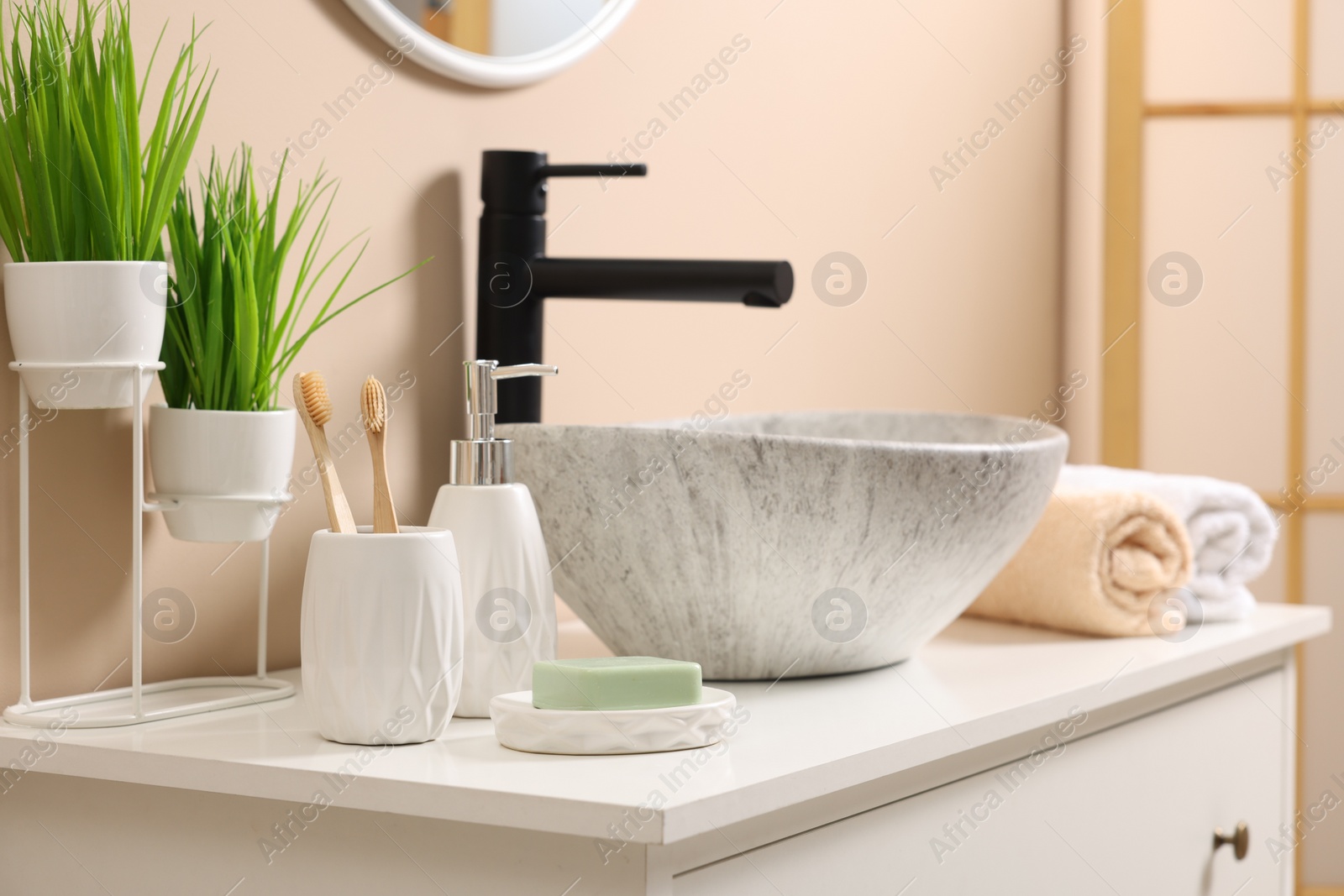 Photo of Different bath accessories and personal care products near sink on bathroom vanity