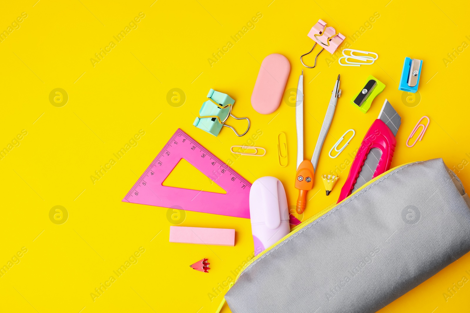 Photo of Flat lay composition with different school stationery on yellow background, space for text. Back to school