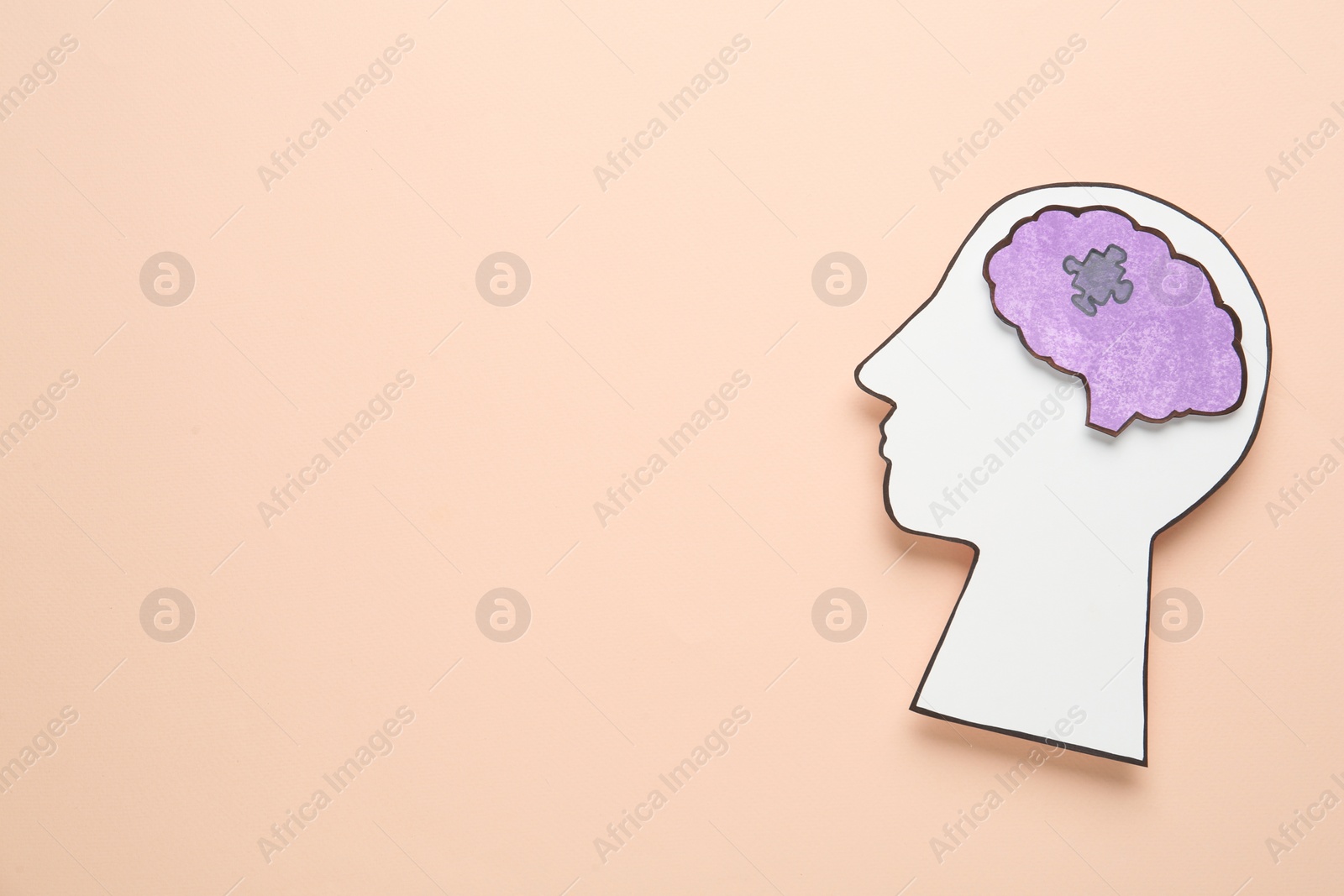 Photo of Top view of human head cutout with brain on beige background, space for text. Epilepsy awareness