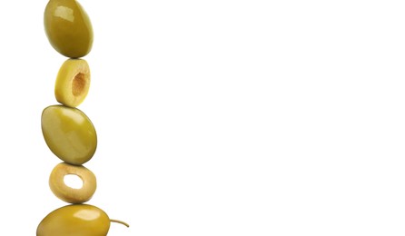 Cut and whole green olives on white background