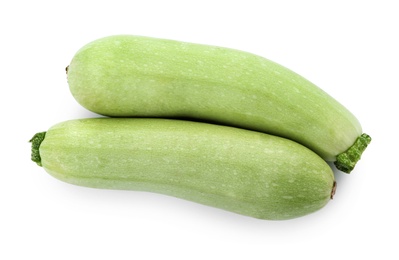 Fresh ripe zucchini squashes on white background, top view