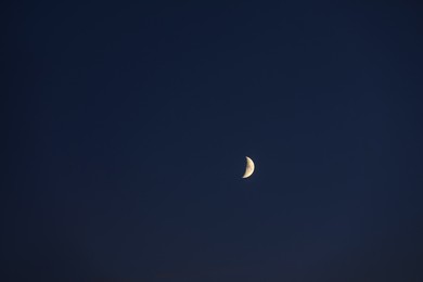 Photo of Beautiful bright white crescent in dark blue sky