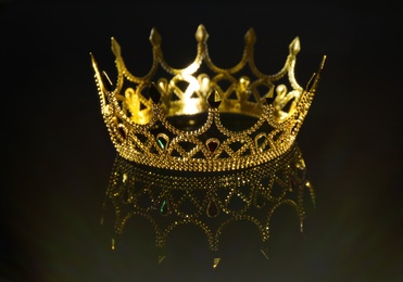 Photo of Beautiful golden crown on black background. Fantasy item
