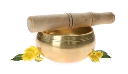 Golden singing bowl with mallet and flowers on white background. Sound healing