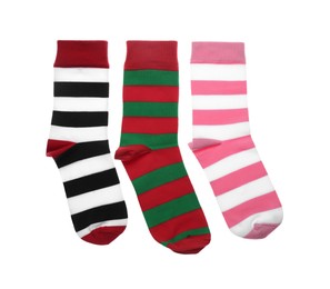 Photo of Different striped socks on white background, top view