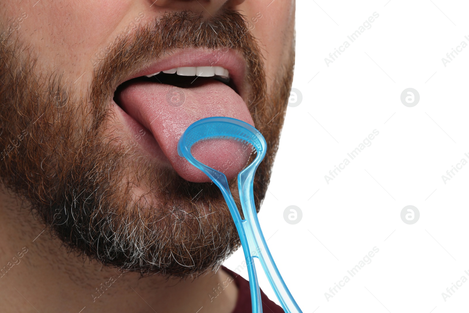 Photo of Man brushing his tongue with cleaner on white background, closeup