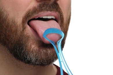 Photo of Man brushing his tongue with cleaner on white background, closeup