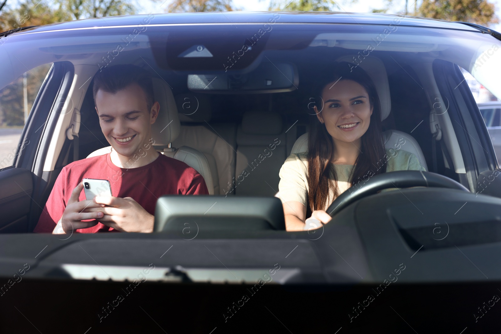 Photo of Happy young couple travelling together by car