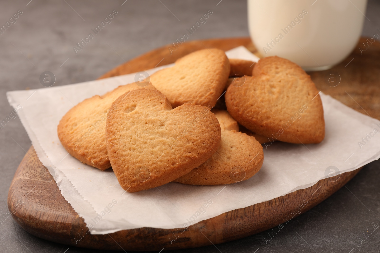 Photo of Heart shaped Danish butter cookies on grey table, closeup