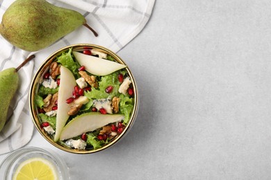 Photo of Delicious pear salad in bowl and fruits on light table, flat lay. Space for text