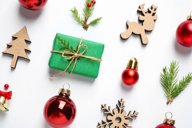 Flat lay composition with Christmas gift and festive decor on white background