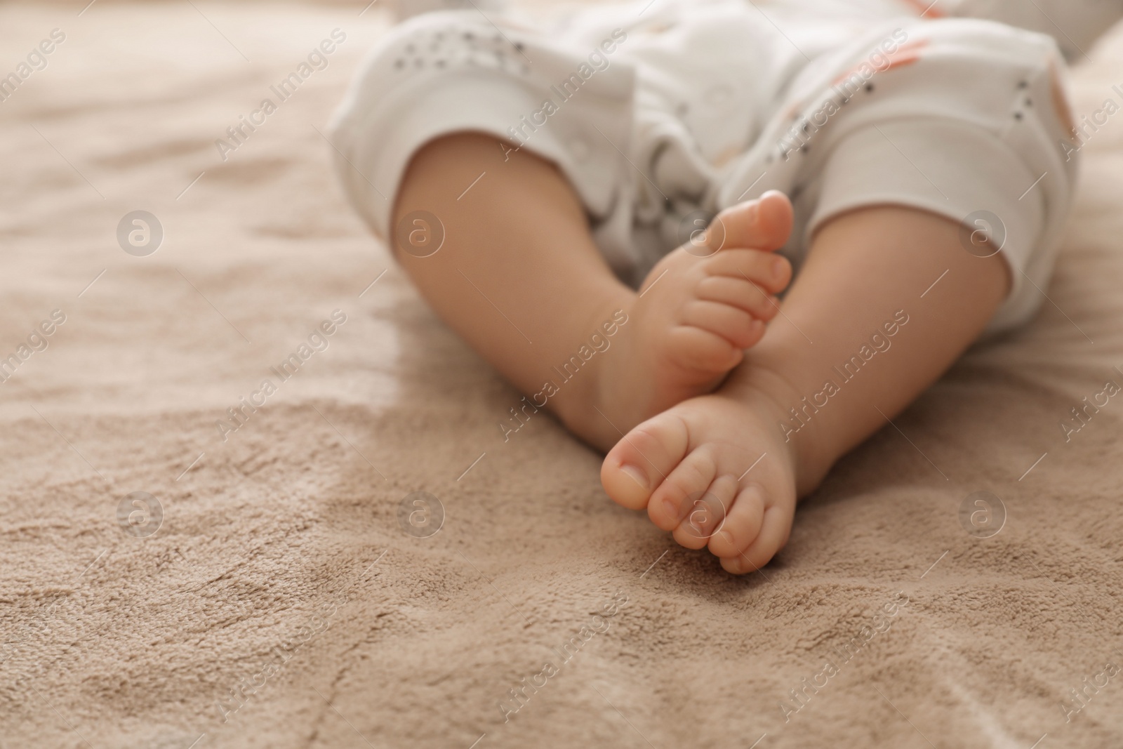 Photo of Little baby on brown blanket, closeup view