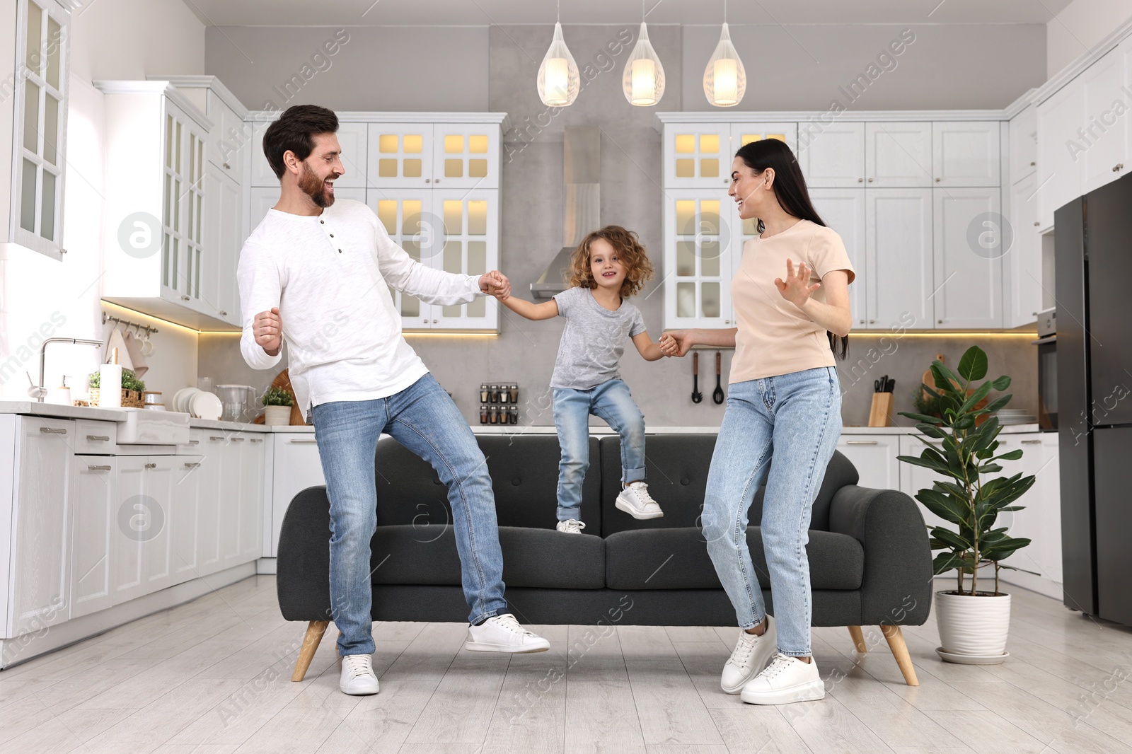 Photo of Happy family dancing and having fun at home, low angle view